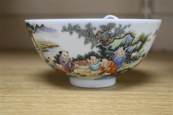 A Chinese porcelain bowl, painted with infants in a landscape, diam. 13.5cm